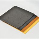View of three clearance rubber sheets stacked up against white background 