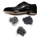 View of a Black Leather Shoe and piles of TR Lawman Tacks and Nails